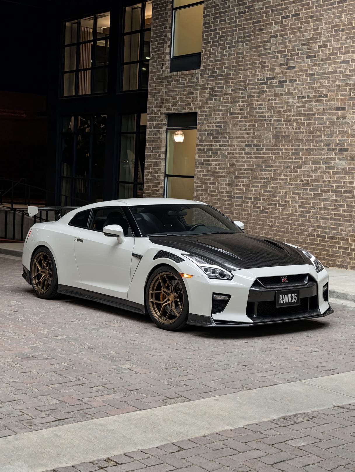 Pearl white Nissan GT-R R35 with carbon hood and bronze wheels